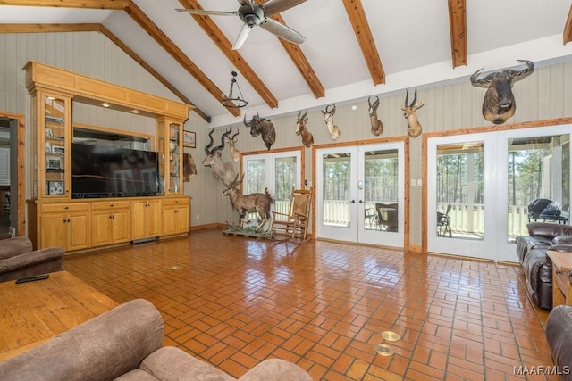 2714 County Road 54, Ozark, AL 36360 - unfurnished living room with high vaulted ceiling, ceiling fan, beam ceiling, brick floor, and french doors