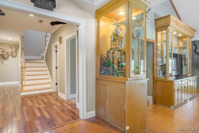 2714 County Road 54, Ozark, AL 36360 - hall with stairs, ornamental molding, baseboards, brick floor, and visible vents