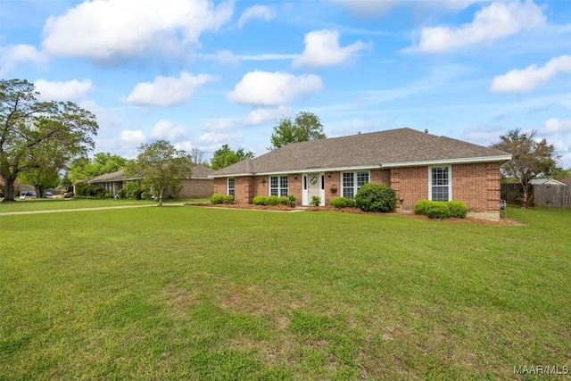 ranch-style house with brick siding and a front yard