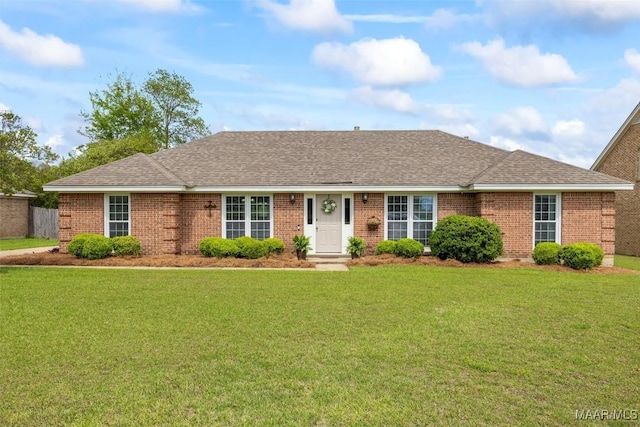 ranch-style house with brick siding, a front yard, and a shingled roof