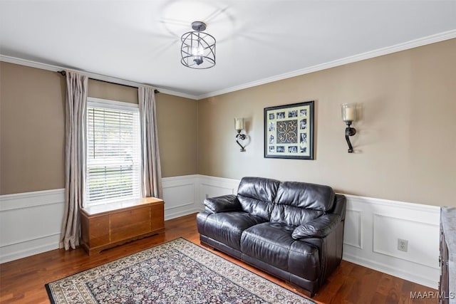 living room featuring a wainscoted wall, wood finished floors, and ornamental molding