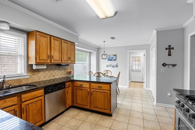 kitchen featuring a sink, stainless steel appliances, and brown cabinetry
