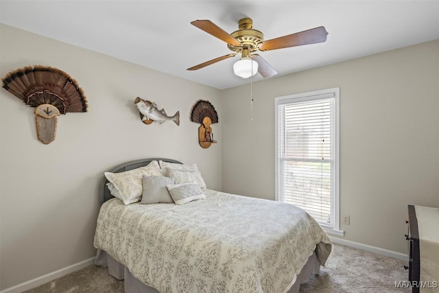 bedroom with a ceiling fan, carpet, and baseboards