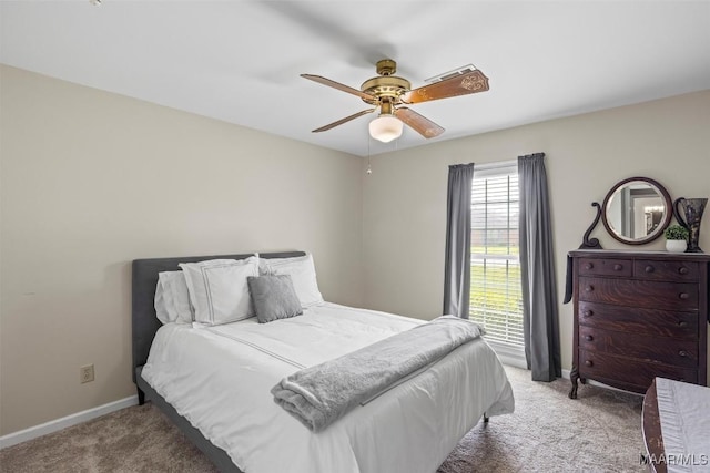 bedroom with baseboards, carpet flooring, and a ceiling fan