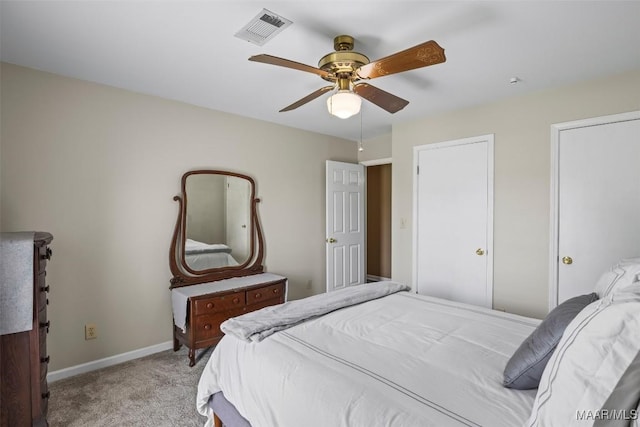 carpeted bedroom featuring baseboards, ceiling fan, and visible vents