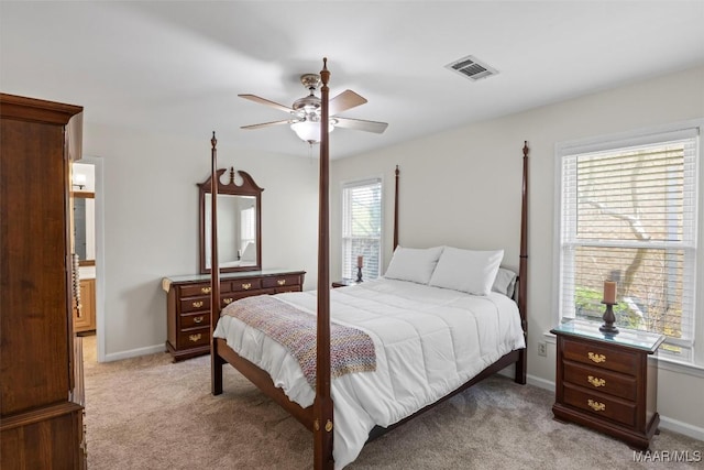 bedroom featuring baseboards, visible vents, a ceiling fan, and light carpet