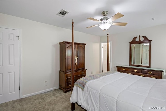 bedroom featuring baseboards, visible vents, a ceiling fan, and light colored carpet
