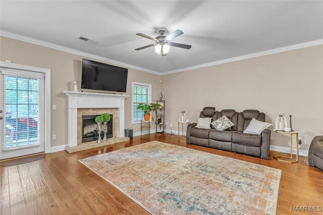 126 N Dogwood Ter, Wetumpka, AL 36093 - living area with ceiling fan, ornamental molding, wood finished floors, a tile fireplace, and baseboards