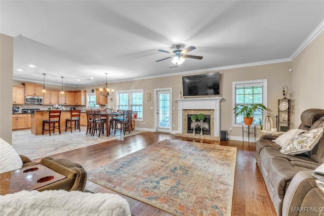 126 N Dogwood Ter, Wetumpka, AL 36093 - living room featuring plenty of natural light, ceiling fan, crown molding, light wood finished floors, and a fireplace with raised hearth