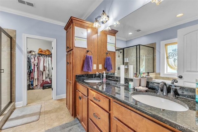 126 N Dogwood Ter, Wetumpka, AL 36093 - bathroom with a stall shower, crown molding, a walk in closet, double vanity, and tile patterned floors