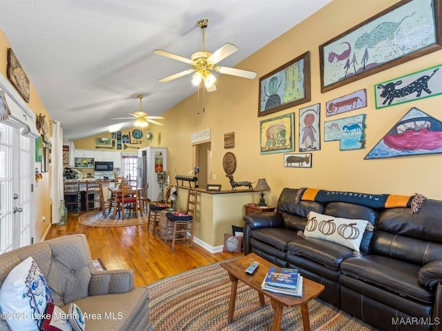 197 Maple Ridge Rd, Alexander City, AL 35010 - living room with wood finished floors, baseboards, vaulted ceiling, and ceiling fan