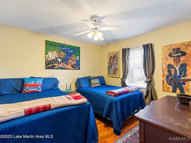 197 Maple Ridge Rd, Alexander City, AL 35010 - bedroom featuring a textured ceiling, wood finished floors, and a ceiling fan