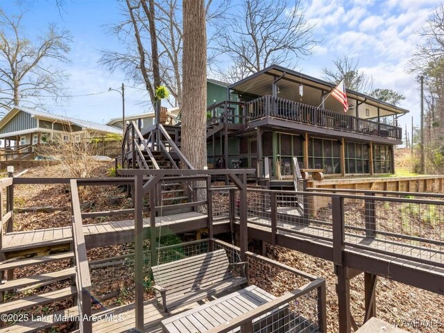 197 Maple Ridge Rd, Alexander City, AL 35010 - back of property featuring a sunroom, a wooden deck, and stairs