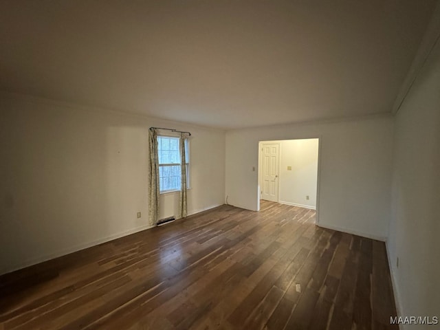 114 Dogwood Cir, Ozark, AL 36360 - spare room with dark wood-style flooring, baseboards, and visible vents