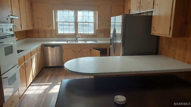 114 Dogwood Cir, Ozark, AL 36360 - kitchen featuring light countertops, wood walls, stainless steel appliances, light wood finished floors, and light brown cabinetry