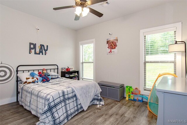 bedroom featuring light wood-type flooring and a ceiling fan