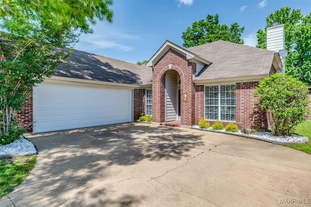 view of front of home featuring brick siding, driveway, roof with shingles, and an attached garage