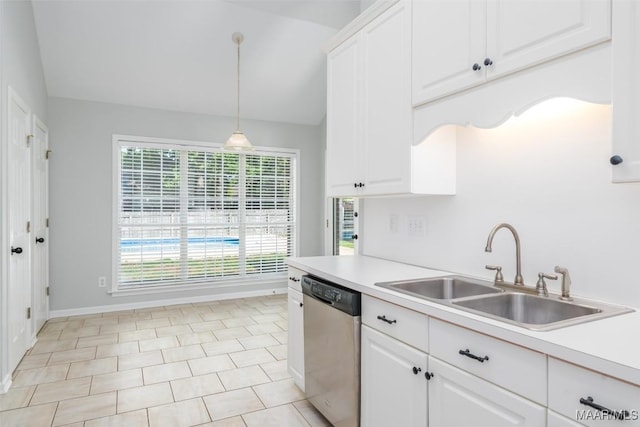kitchen with stainless steel dishwasher, a sink, lofted ceiling, light countertops, and white cabinetry