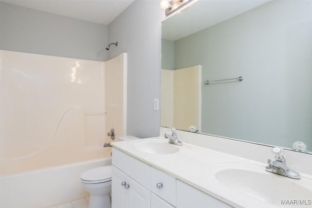 full bath with toilet, tile patterned floors, double vanity, and shower / washtub combination