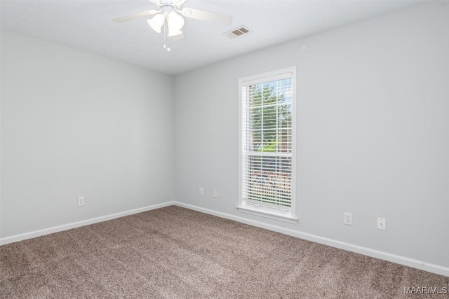 unfurnished room featuring carpet, baseboards, and a ceiling fan