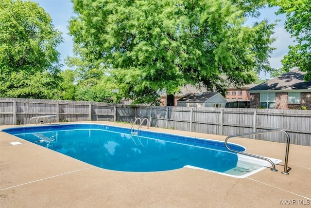 view of swimming pool featuring a patio and a fenced backyard