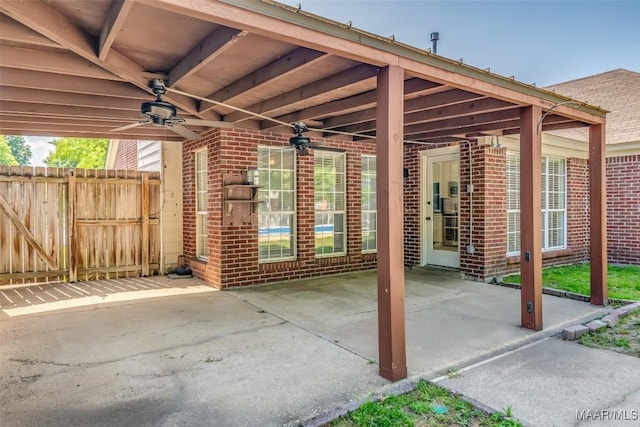 view of patio featuring ceiling fan and fence