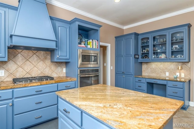 kitchen featuring custom range hood, blue cabinets, and appliances with stainless steel finishes