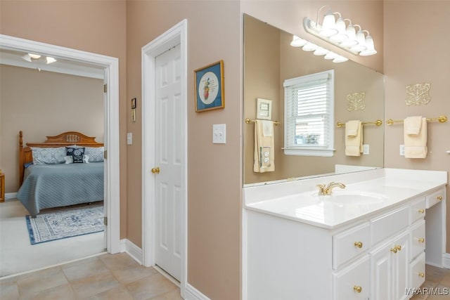 bathroom featuring tile patterned flooring, baseboards, connected bathroom, and vanity