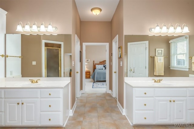 ensuite bathroom with a shower stall, a sink, tile patterned flooring, and ensuite bath