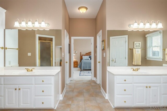 8681 Huntingdon Ridge Ln, Montgomery, AL 36117 - ensuite bathroom with a stall shower, two vanities, baseboards, and tile patterned floors