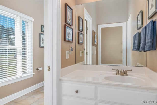 bathroom featuring vanity, baseboards, and tile patterned flooring