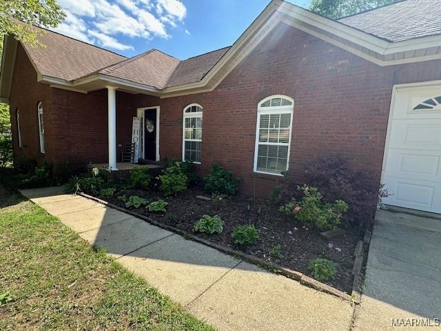 1518 White Cloud Dr, Deatsville, AL 36022 - property entrance with a porch, brick siding, and an attached garage