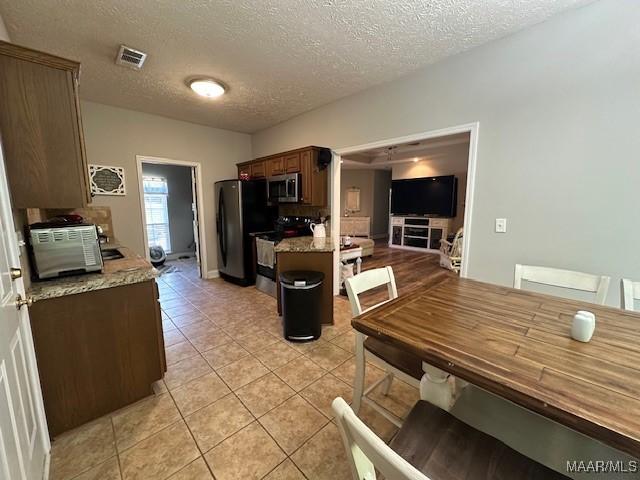 1518 White Cloud Dr, Deatsville, AL 36022 - dining area with visible vents, a textured ceiling, and light tile patterned flooring