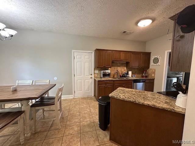 1518 White Cloud Dr, Deatsville, AL 36022 - kitchen with visible vents, dishwasher, a sink, backsplash, and light tile patterned flooring