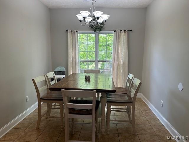 1518 White Cloud Dr, Deatsville, AL 36022 - tiled dining room with a chandelier, baseboards, and a textured ceiling