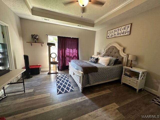 1518 White Cloud Dr, Deatsville, AL 36022 - bedroom with a tray ceiling, a textured ceiling, and wood finished floors