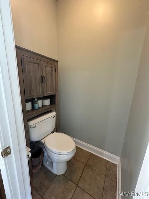 1518 White Cloud Dr, Deatsville, AL 36022 - bathroom featuring toilet, tile patterned floors, and baseboards