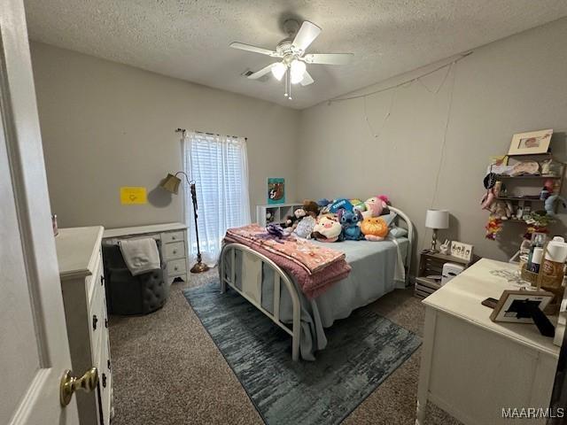 1518 White Cloud Dr, Deatsville, AL 36022 - bedroom with dark colored carpet, a textured ceiling, and ceiling fan