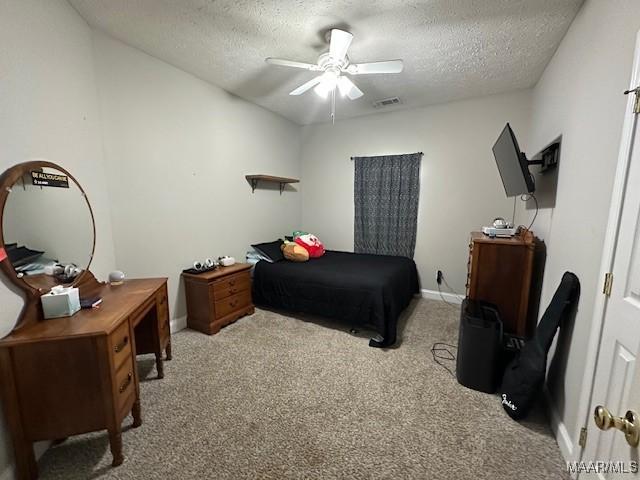 1518 White Cloud Dr, Deatsville, AL 36022 - carpeted bedroom with a textured ceiling, baseboards, and ceiling fan