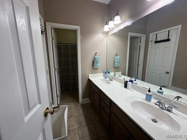 1518 White Cloud Dr, Deatsville, AL 36022 - full bath featuring a sink, tile patterned floors, double vanity, and baseboards