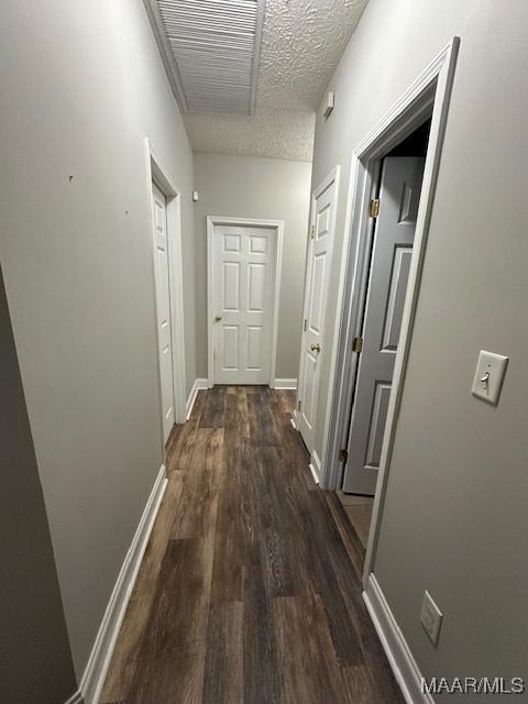 1518 White Cloud Dr, Deatsville, AL 36022 - hallway with dark wood-type flooring, visible vents, a textured ceiling, and baseboards