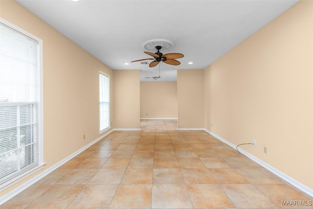 spare room featuring light tile patterned flooring, baseboards, a ceiling fan, and recessed lighting