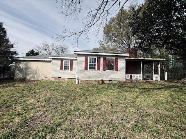 ranch-style home featuring a front yard, crawl space, a chimney, and covered porch