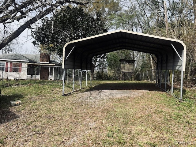 view of yard with a carport and fence