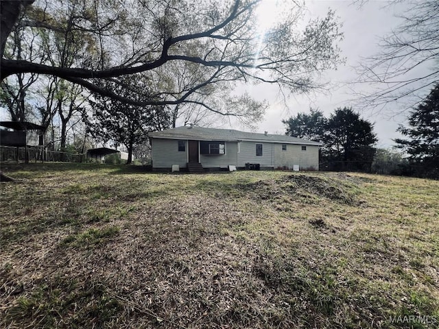exterior space with a carport, entry steps, fence, and a chimney