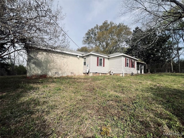 view of property exterior featuring crawl space and a lawn