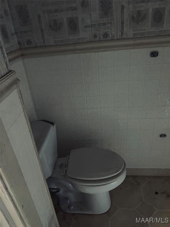bathroom with toilet and tile patterned floors