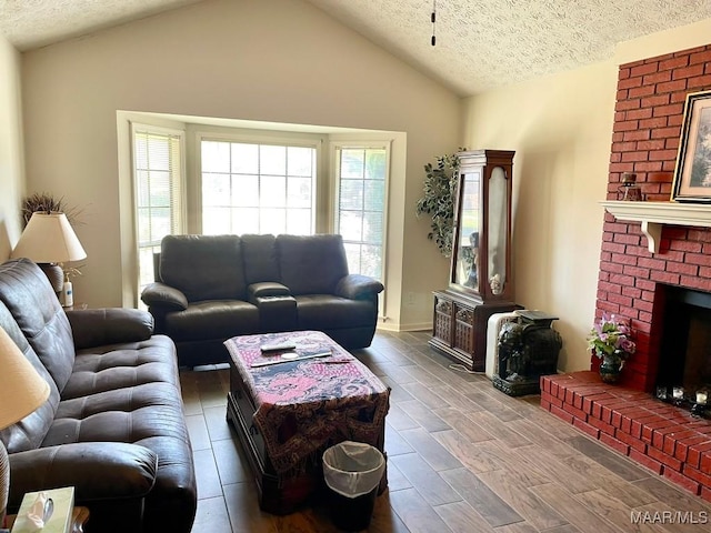 living area with a fireplace, wood finished floors, vaulted ceiling, and a textured ceiling