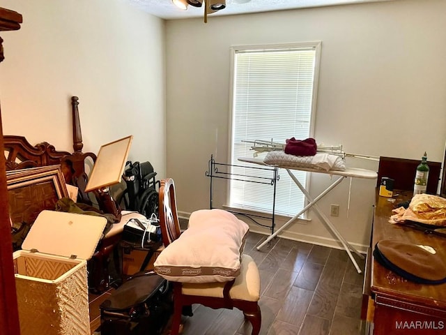 misc room featuring dark wood-style flooring and baseboards