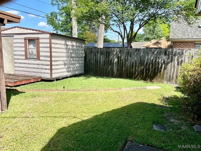 view of yard with a shed, fence, and an outdoor structure